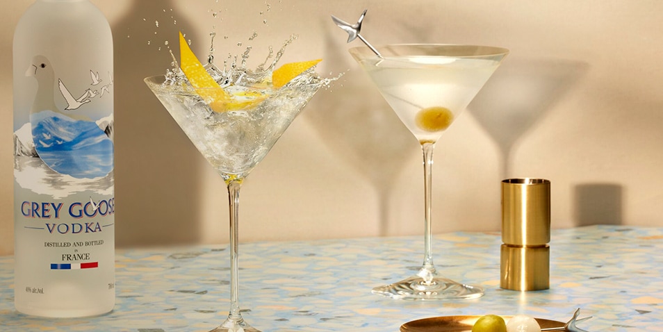 A bottle of Grey Goose vodka, a Classic Dry Martini Cocktail and a Dirty Martini Cocktail.
